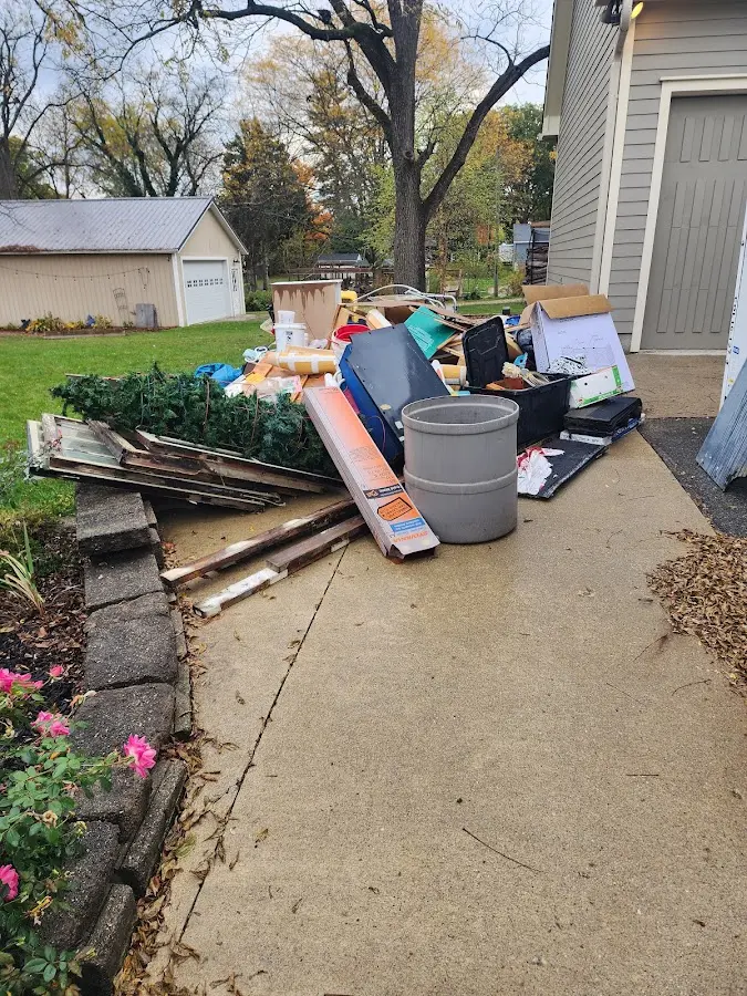 Dumpster being loaded with debris for Roofing Dumpster Rental in Silver Springs